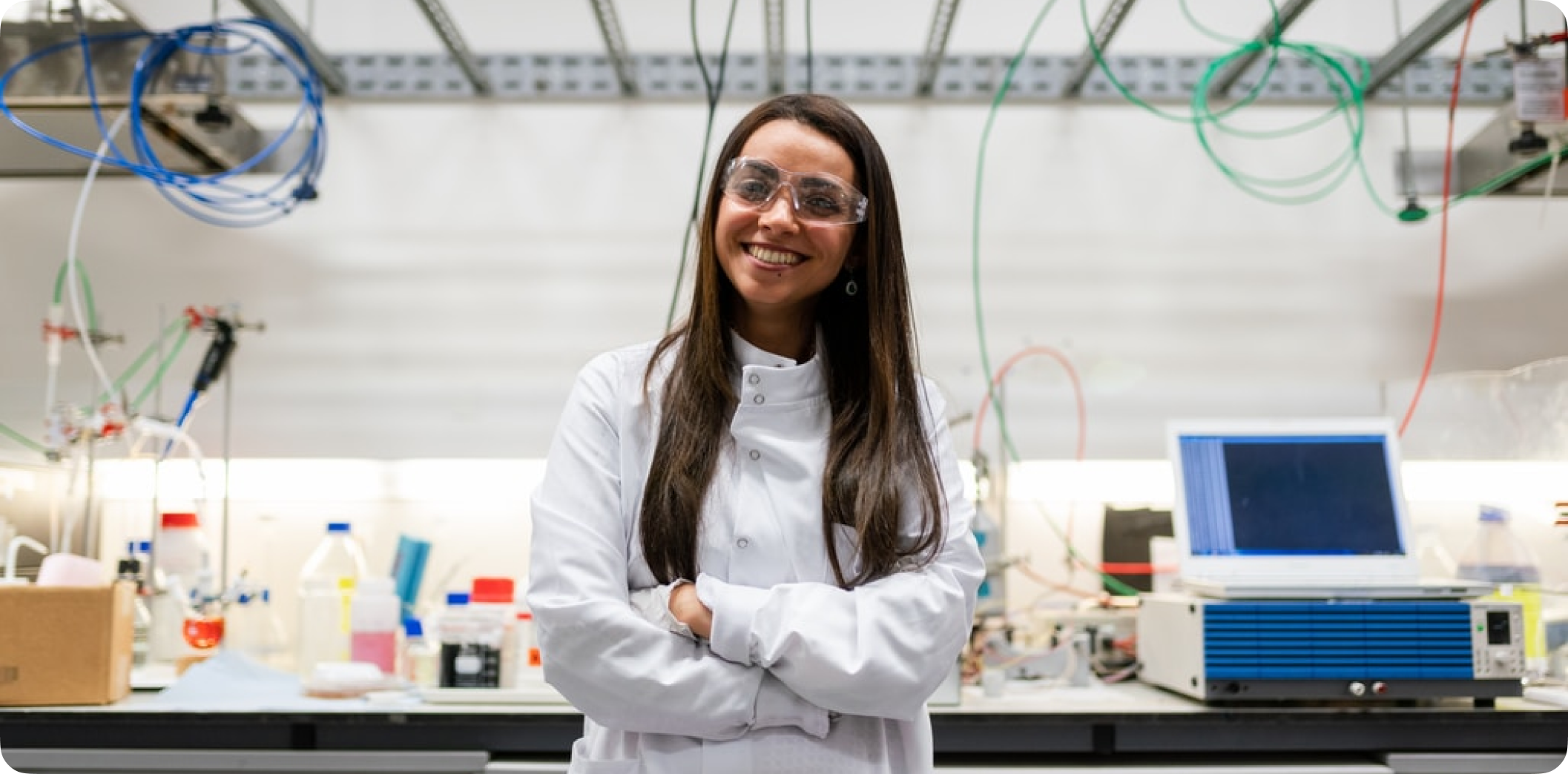a woman wearing a lab coat and goggles